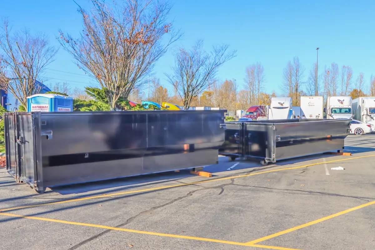 Professional dumpster rental service with roll-off container on residential driveway in Wolcott